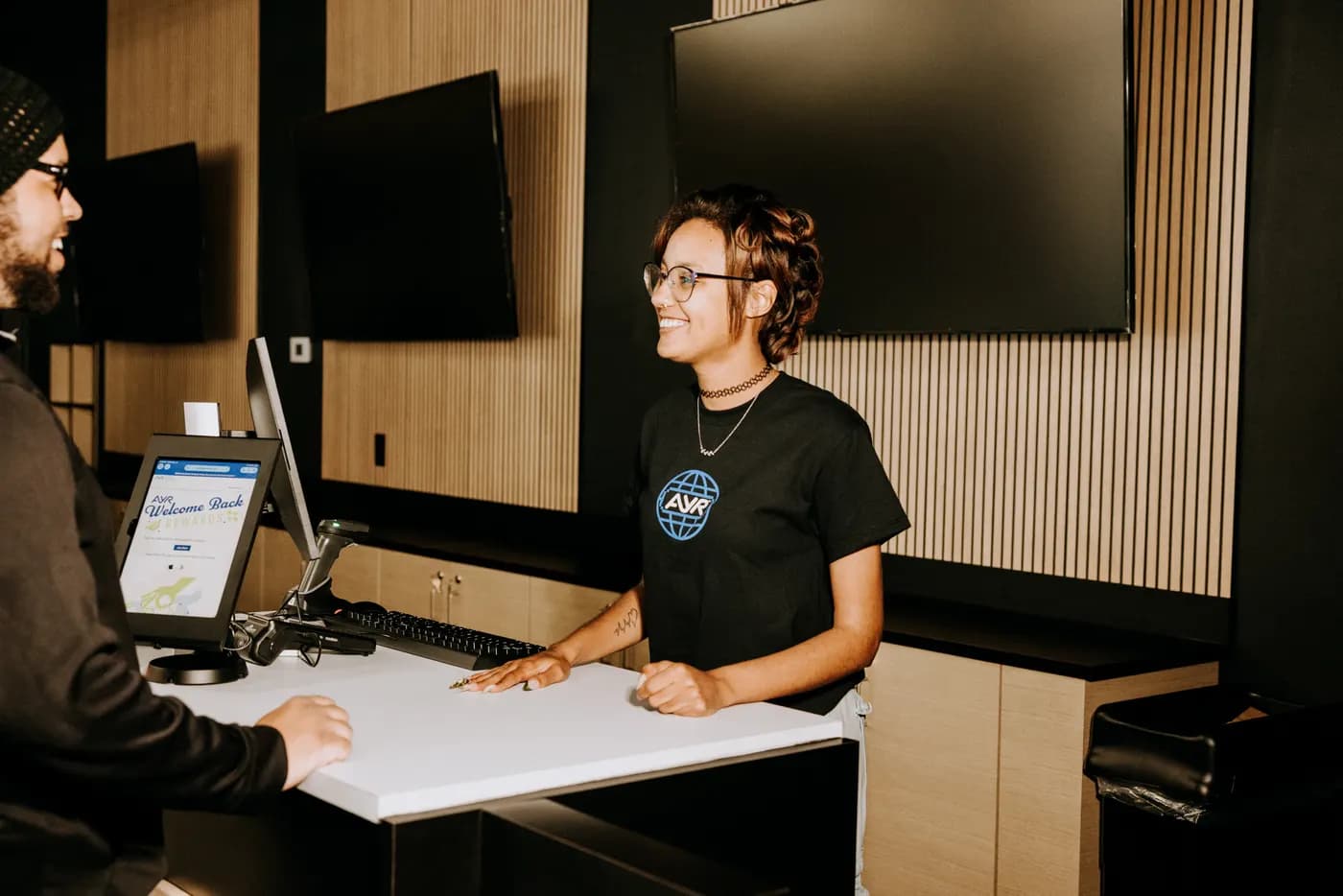 A budtender helping a customer at Ayr Cannabis Dispensary Eustis